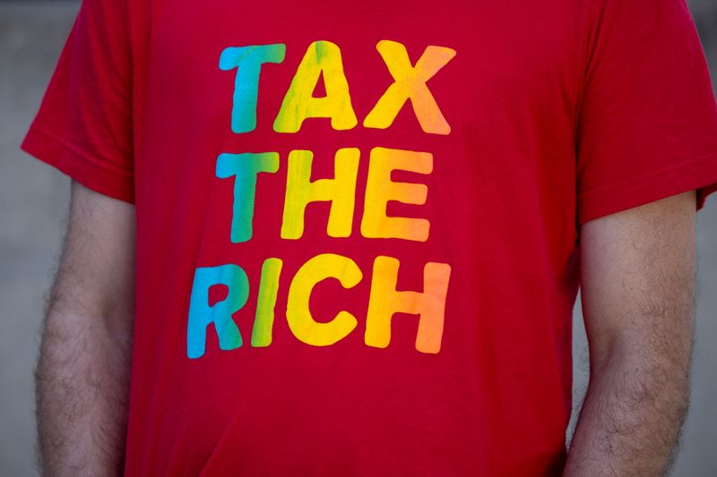 &copy; Reuters. FILE PHOTO: A demonstrator wears a "Tax the Rich" T-shirt during a national day of resistance to demand a safe, scientific, racially just and fully funded approach to reopening schools during the outbreak of the coronavirus disease (COVID-19) in Los Angel