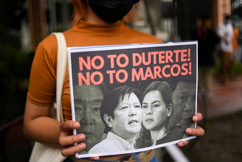 &copy; Reuters. FILE PHOTO: A demonstrator holds a poster during a protest following the presidential bid announcement of Ferdinand “Bongbong” Marcos Jr., son of late dictator Ferdinand Marcos, at the Commission of Human Rights, in Quezon City, Metro Manila, Philippi