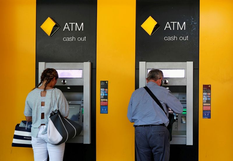 &copy; Reuters. FILE PHOTO: People use Commonwealth Bank of Australia (CBA) bank ATMs in Sydney, Australia May 3, 2018. REUTERS/Edgar Su