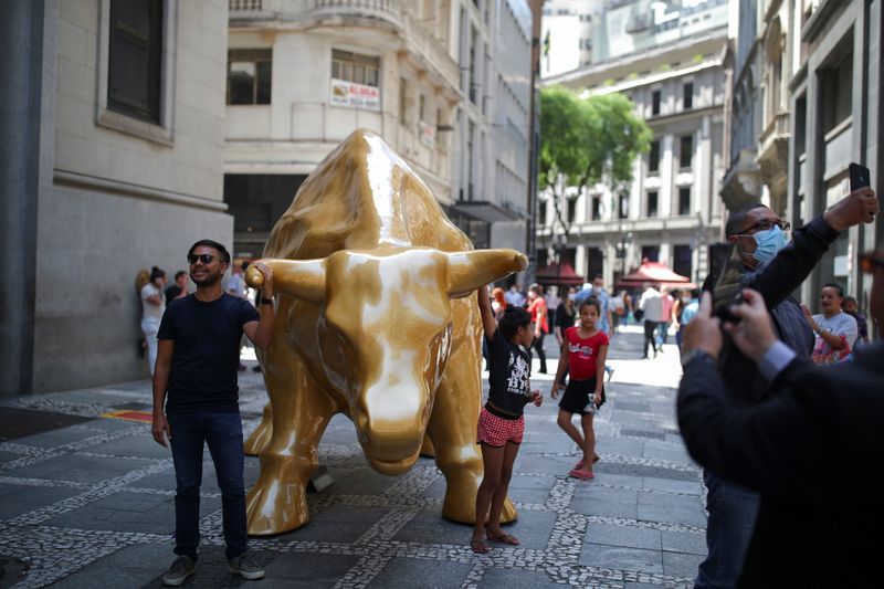 &copy; Reuters. FILE PHOTO: People pose and take pictures of the Golden Bull, a sculpture inaugurated by Brazilian B3 Stock Exchange, symbolizing the financial market, in Sao Paulo, Brazil, November 16, 2021. REUTERS/Amanda Perobelli