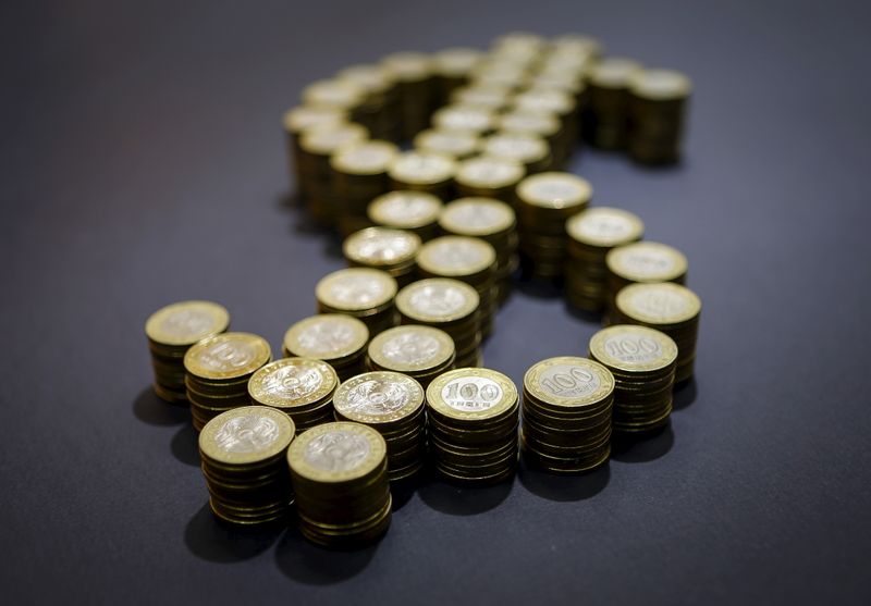 &copy; Reuters. A picture illustration shows Kazakhstan's 100 tenge coins form a U.S. dollar symbol in Almaty, Kazakhstan, November 6, 2015. The weighted average of the Kazakh tenge fell to 307.53 per dollar, a fresh all-time closing low, on the Kazakhstan Stock Exchange