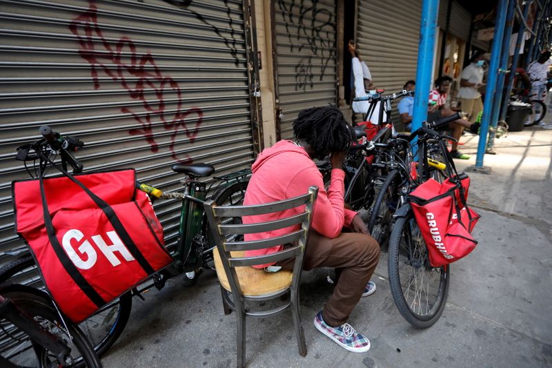 &copy; Reuters. FILE PHOTO: Riders for "Grubhub" food delivery service congregate between deliveries in midtown Manhattan following the outbreak of the coronavirus disease (COVID-19) in New York City, New York, U.S., July 9, 2020. REUTERS/Mike Segar