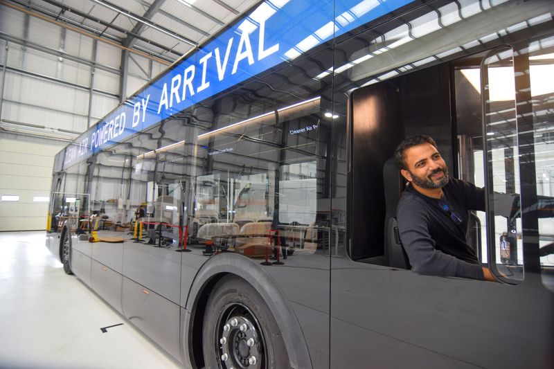 &copy; Reuters. Avinash Rugoobur, president of electric van and bus maker Arrival, shows off the startup's pre-production electric bus model at the company's research and development centre in Banbury, Britain, November 15, 2021. Picture taken November 15, 2021. REUTERS/