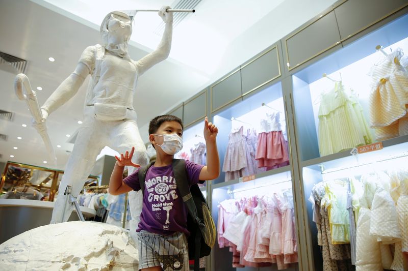 &copy; Reuters. FILE PHOTO: A child poses next to the two-meter-tall "Lady Liberty", a symbolic statue placed by pro-democracy protesters at a Chickeeduck branch in Hong Kong, China June 18, 2020. REUTERS/Tyrone Siu/File Photo