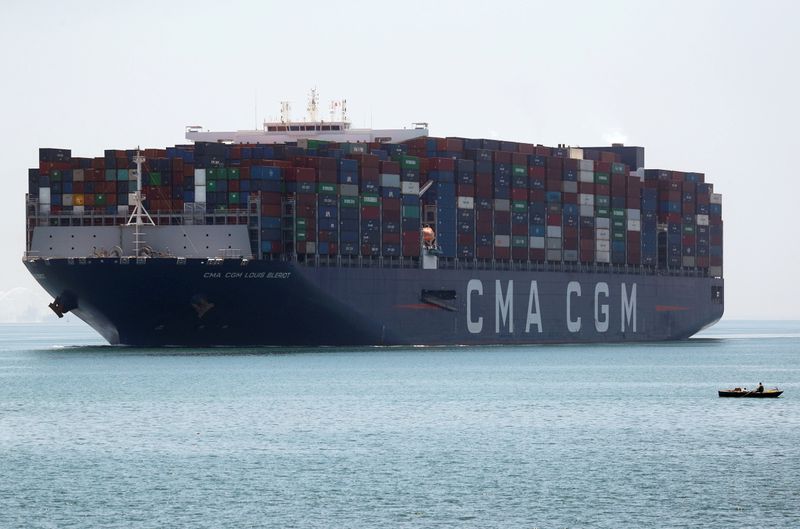 &copy; Reuters. FILE PHOTO: A fisherman travels on a boat in front of a CMA CGM container ship passing through the Suez Canal in Ismailia, Egypt July 7, 2021. REUTERS/Amr Abdallah Dalsh