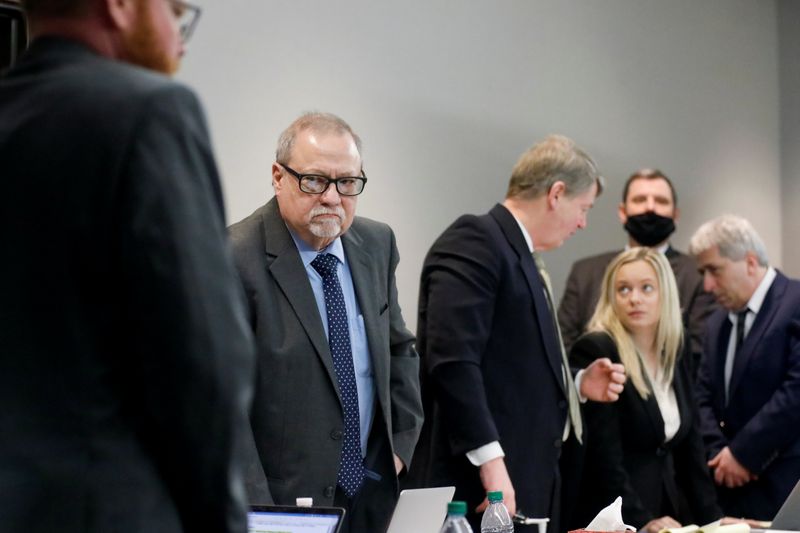 &copy; Reuters. Defendants William "Roddie" Bryan, Travis McMichael and Gregory McMichael, charged with the February 2020 death of 25-year-old Ahmaud Arbery, and defence attorney Kevin Gough, stand during the trial at Glynn County Superior Court in Brunswick, Georgia, U.