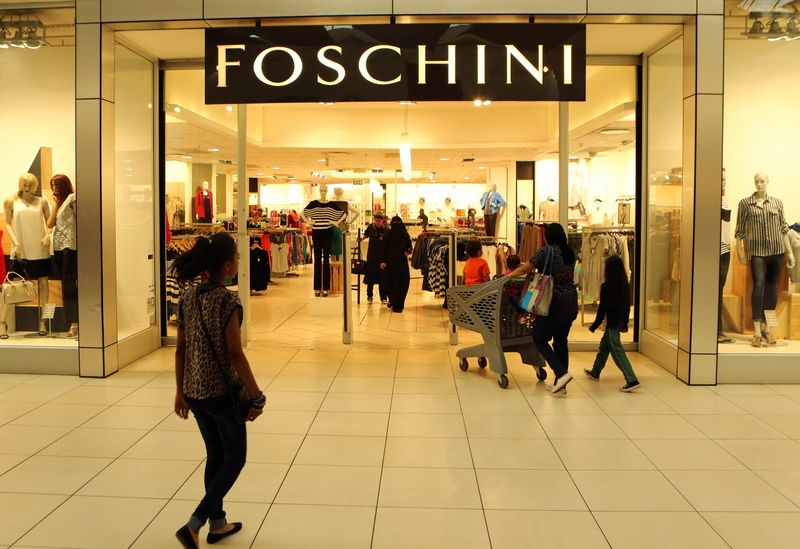 &copy; Reuters. FILE PHOTO: A shopper walks past a Foschini store at a shopping centre in Lenasia, south of Johannesburg, August 28, 2013.  REUTERS/Siphiwe Sibeko