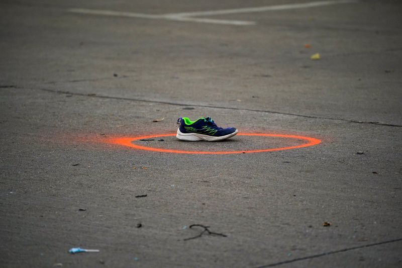 &copy; Reuters. A shoe circled in spray paint to mark as evidence is seen on Main Street the morning after a car plowed through a holiday parade in Waukesha, Wisconsin, U.S., November 22, 2021.  REUTERS/Cheney Orr   