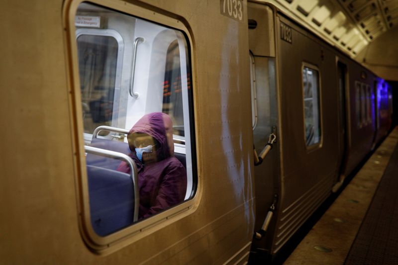 &copy; Reuters. FILE PHOTO: A passenger wears a protective face mask aboard a Washington Metro Rail Car in Washington, U.S., December 17, 2020. REUTERS/Tom Brenner/File Photo