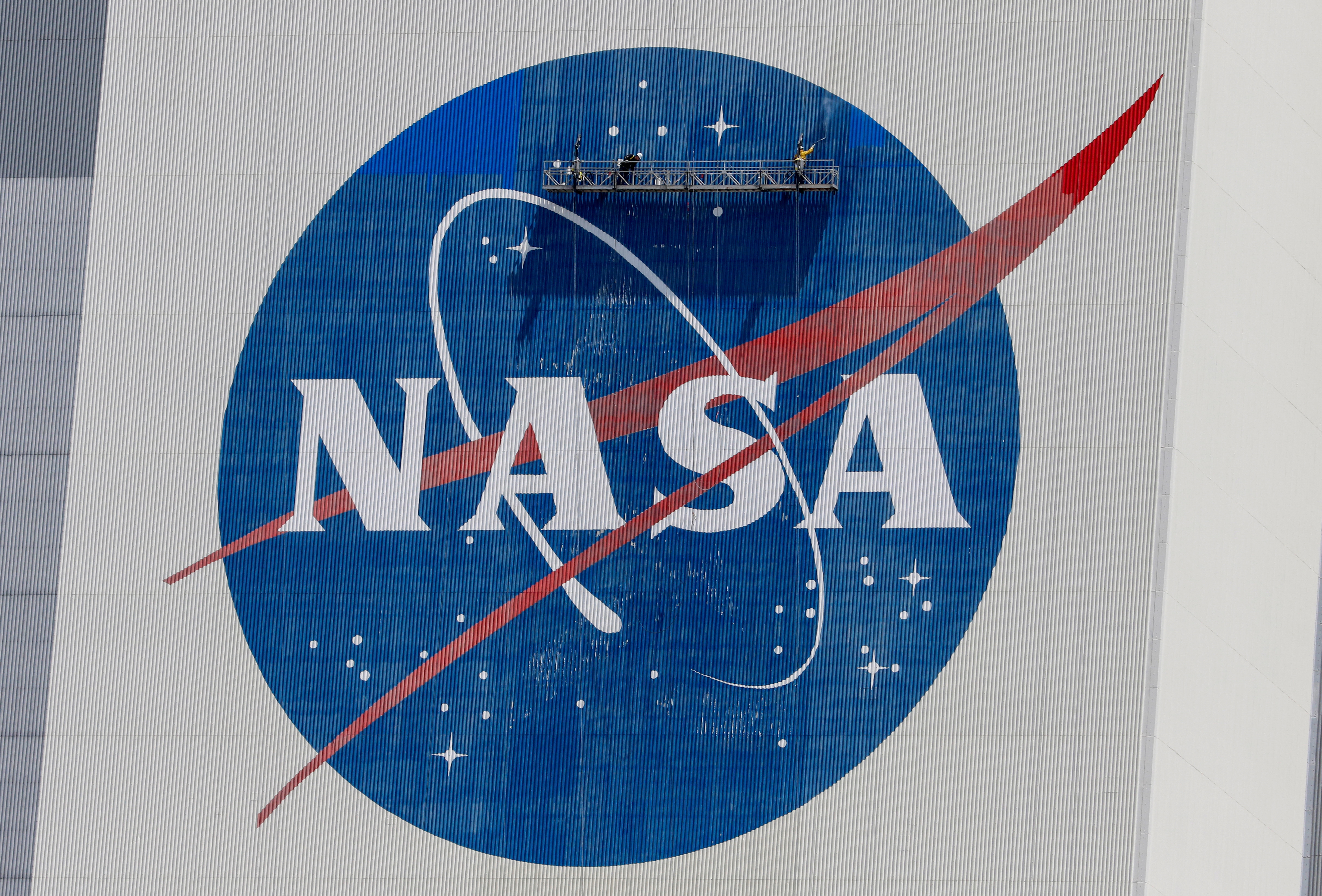 &copy; Reuters. FILE PHOTO: Workers pressure wash the logo of NASA on the Vehicle Assembly Building before SpaceX will send two NASA astronauts to the International Space Station aboard its Falcon 9 rocket, at the Kennedy Space Center in Cape Canaveral, Florida, U.S., Ma