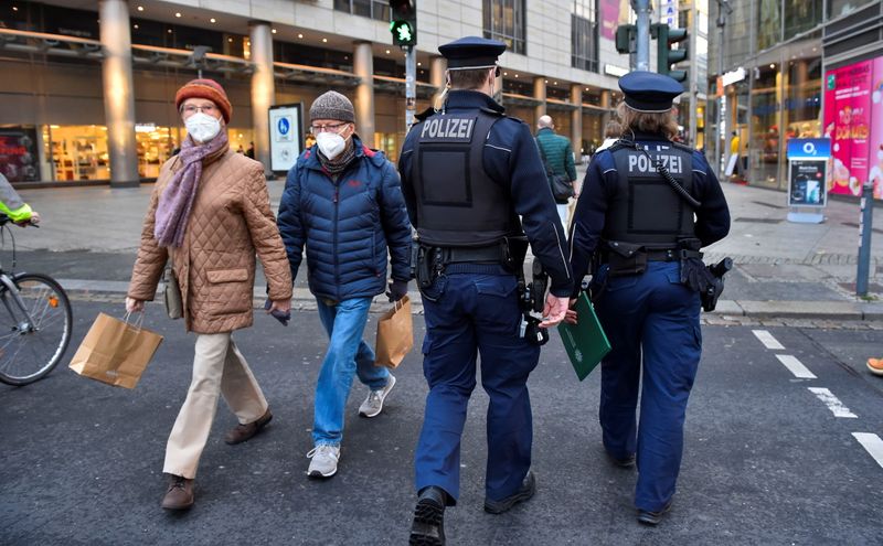 &copy; Reuters. FILE PHOTO: Police officers walk along a shopping street as they check the coronavirus disease (COVID-19) protocol in Dresden, Germany, November 23, 2021. REUTERS/Matthias Rietschel