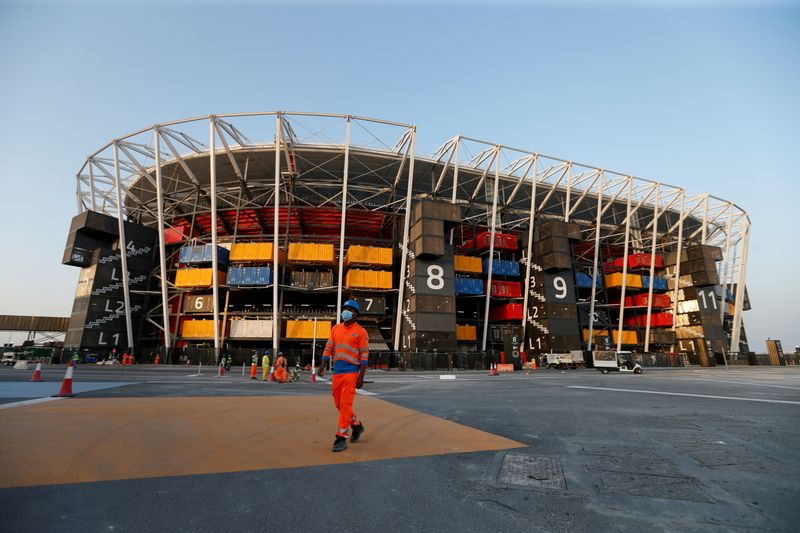 &copy; Reuters. FILE PHOTO: A worker walks in front of Ras Abu Aboud Stadium, one of the venues of the Qatar World Cup 2022, in Doha, Qatar, November 17, 2021. Picture taken November 17, 2021. REUTERS/Hamad I Mohammed/File Photo
