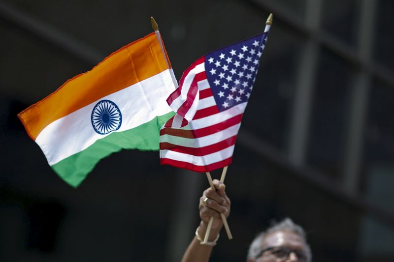 &copy; Reuters. FILE PHOTO: A man holds the flags of India and the U.S. while people take part in the 35th India Day Parade in New York August 16, 2015. REUTERS/Eduardo Munoz