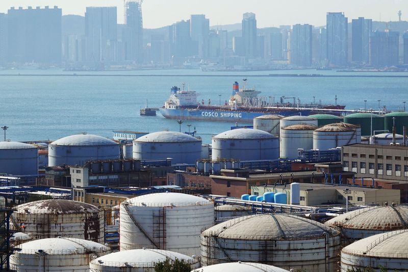 &copy; Reuters. FILE PHOTO: A China Ocean Shipping Company (COSCO) vessel is seen near oil tanks at the China National Petroleum Corporation (CNPC)'s Dalian Petrochemical Corp in Dalian, Liaoning province, China October 15, 2019. REUTERS/Stringer.