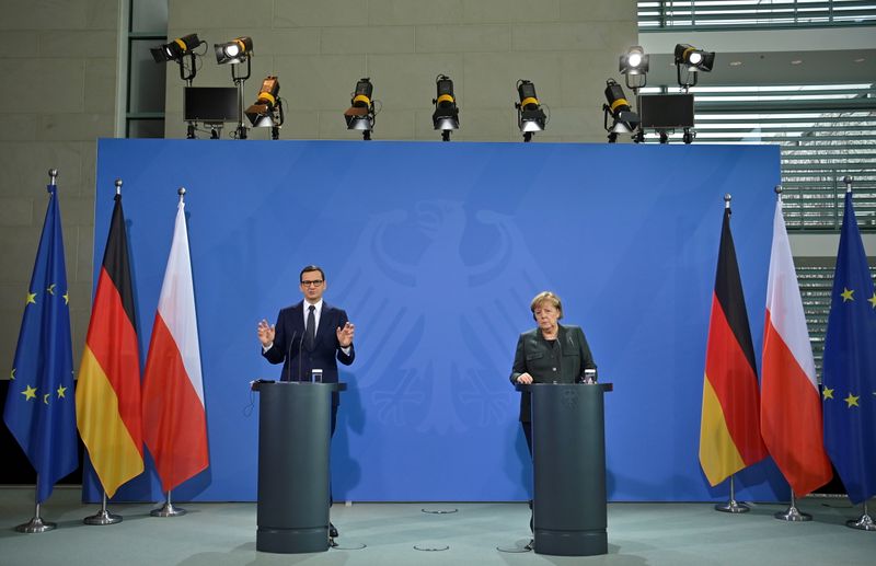 &copy; Reuters. German Chancellor Angela Merkel and Polish Prime Minister Mateusz Morawiecki speak to the media after talks in Berlin, Germany November 25, 2021. John MacDougall/Pool via REUTERS