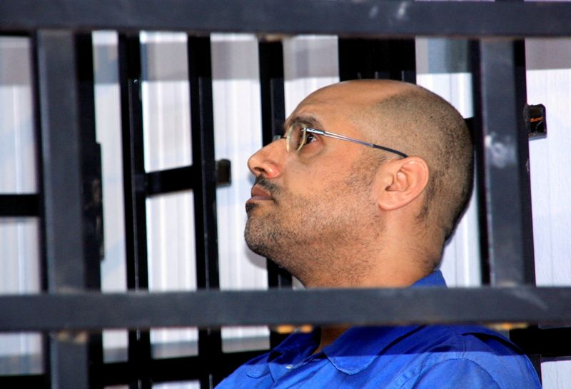 &copy; Reuters. FILE PHOTO: Saif al-Islam Gaddafi, son of late Libyan leader Muammar Gaddafi, attends a hearing behind bars in a courtroom in Zintan, Libya, May 25, 2014. REUTERS/Stringer/File Photo