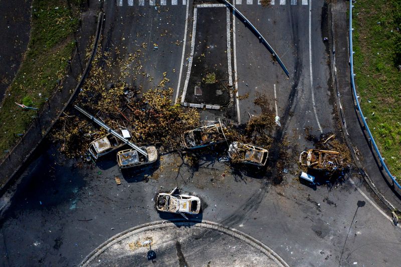 &copy; Reuters. An aerial view of a barricade of burned cars and debris on a round-about blocking the traffic on highway N1 after violent demonstrations which broke out over COVID-19 protocols, in Petit-Bourg, Guadeloupe, November 23, 2021.  REUTERS/Ricardo Arduengo /Fil