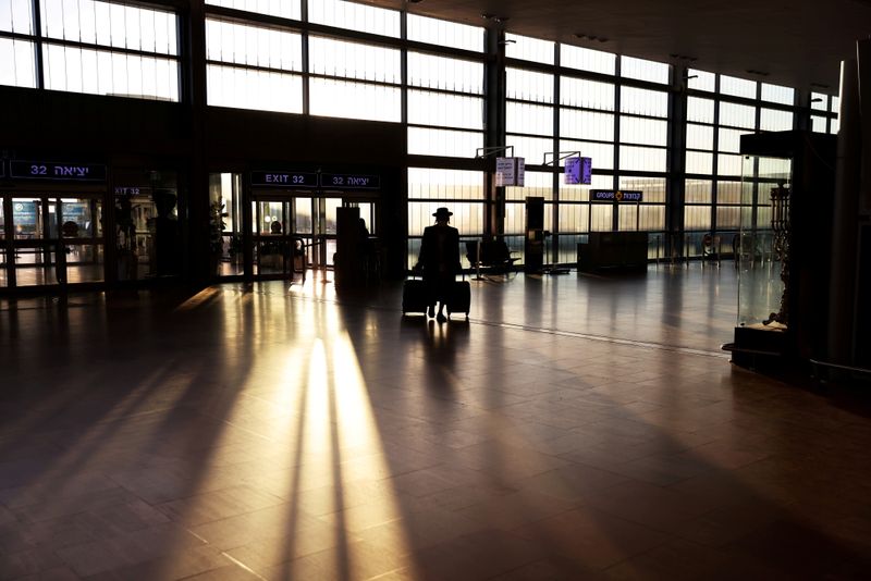 &copy; Reuters. مسافر لدى وصوله إلى مطار بن جوريون في تل أبيب قبل بدء حظر الرحلات الدولية إلى إسرائيل لكبح انتشار فيروس كورونا يوم 25 يناير كانون الثاني 2021. ت