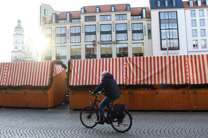 &copy; Reuters. A man rides his bicycle past closed Christmas stands at the market square, amid the coronavirus disease (COVID-19) pandemic, in Leipzig, Germany, November 28, 2021. REUTERS/Annegret Hilse