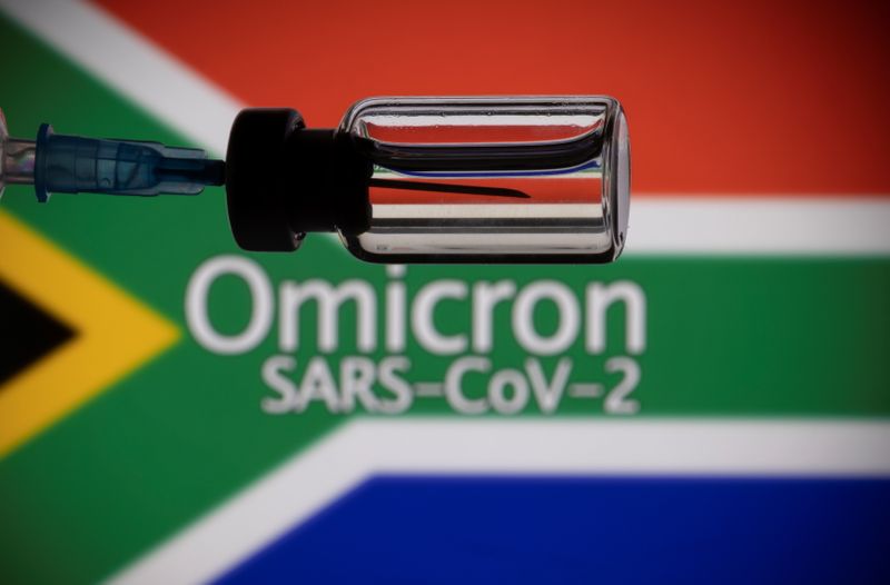 © Reuters. قارورة ومحقن أمام علم جنوب افريقيا وكلمة 