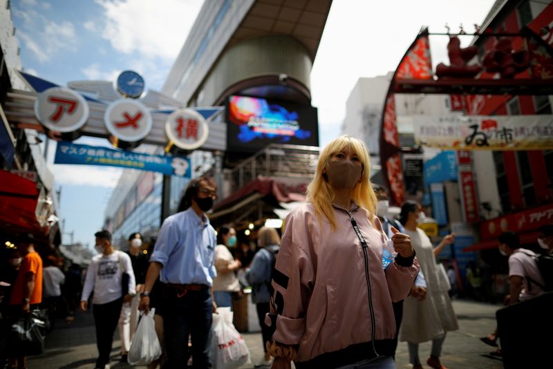 &copy; Reuters. FILE PHOTO: Shoppers walk at the Ameyoko shopping district, also called Ameya-Yokocho, where Tokyo’s biggest street food market is located, in Tokyo, Japan June 5, 2021.  REUTERS/Issei Kato/File Photo