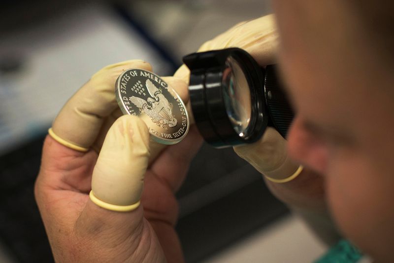 &copy; Reuters. FILE PHOTO: A quality control agent examines a 2013 enhanced silver eagle silver coin at the United States West Point Mint facility in West Point, New York June 5, 2013.  REUTERS/Shannon Stapleton/File Photo