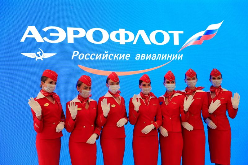 &copy; Reuters. FILE PHOTO: Participants wearing protective face masks pose for a picture at the stand of Aeroflot airlines during the St. Petersburg International Economic Forum (SPIEF) in Saint Petersburg, Russia, June 4, 2021. REUTERS/Evgenia Novozhenina/File Photo