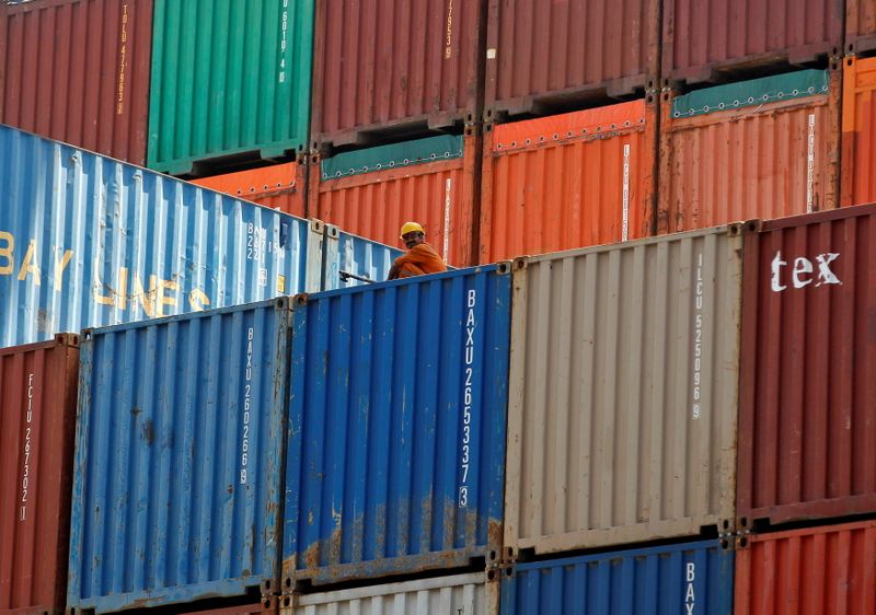 &copy; Reuters. FILE PHOTO: A worker sits on a ship carrying containers at Mundra Port in the western Indian state of Gujarat April 1, 2014. REUTERS/Amit Dave