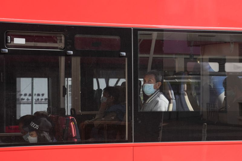 &copy; Reuters. People wearing face masks to prevent the spread of the coronavirus disease (COVID-19), ride in a bus in Hong Kong, China November 29, 2021. REUTERS/Lam Yik