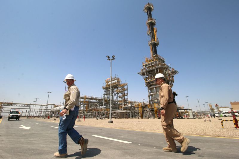 &copy; Reuters. FILE PHOTO: A member of security foreign personnel walks with an Exxon's foreign staff of the West Qurna-1 oilfield, which is operated by ExxonMobil, during the opening ceremony near Basra, Iraq June 17, 2019.  REUTERS/Essam Al-Sudani