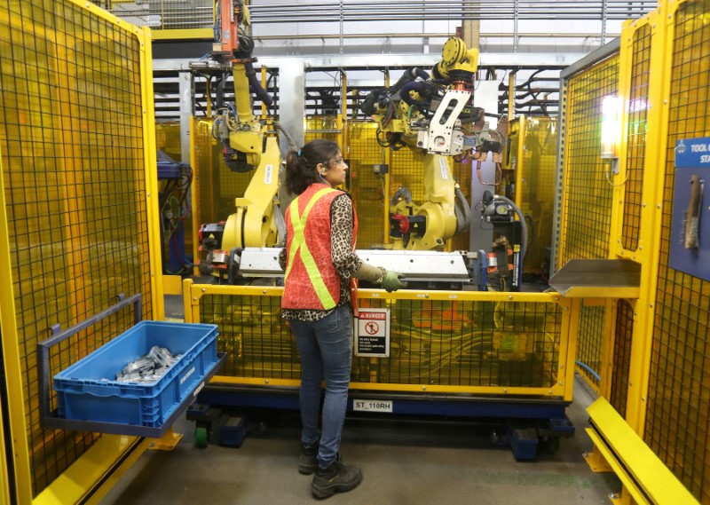 &copy; Reuters. FILE PHOTO: Worker loads part for welding in robot bay at Alfield Industries, a subsidiary of Martinrea, one of three global auto parts makers in Canada, in Vaughan, Ontario, Canada April 28, 2017. REUTERS/Fred Thornhill/File Photo         