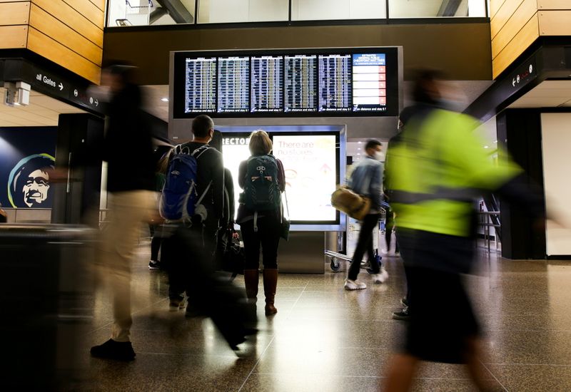 &copy; Reuters. FILE PHOTO: Travellers check a departures list at the ticketing level of Seattle-Tacoma International Airport before the Thanksgiving holiday in Seattle, Washington, U.S. November 24, 2021. REUTERS/Lindsey Wasson/File Photo