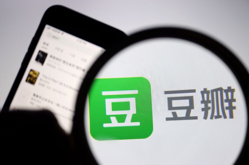 &copy; Reuters. FILE PHOTO: The sign of Chinese social networking forum Douban is seen under a magnifying glass near a mobile phone displaying the Douban app in this picture illustration taken April 14, 2021. REUTERS/Florence Lo/Illustration