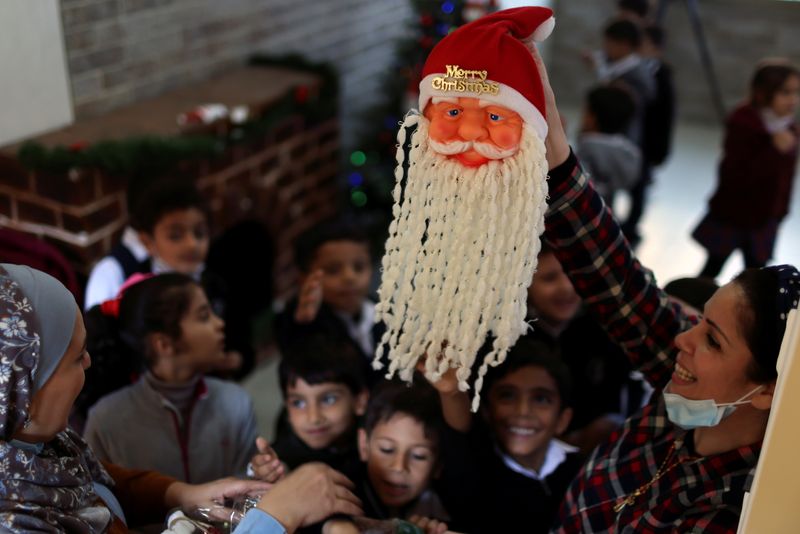 © Reuters. Los niños se preparan para recibir regalos navideños de sus profesoras en la escuela de las Hermanas del Rosario en Gaza. 24 noviembre 2021. REUTERS/Mohammed Salem