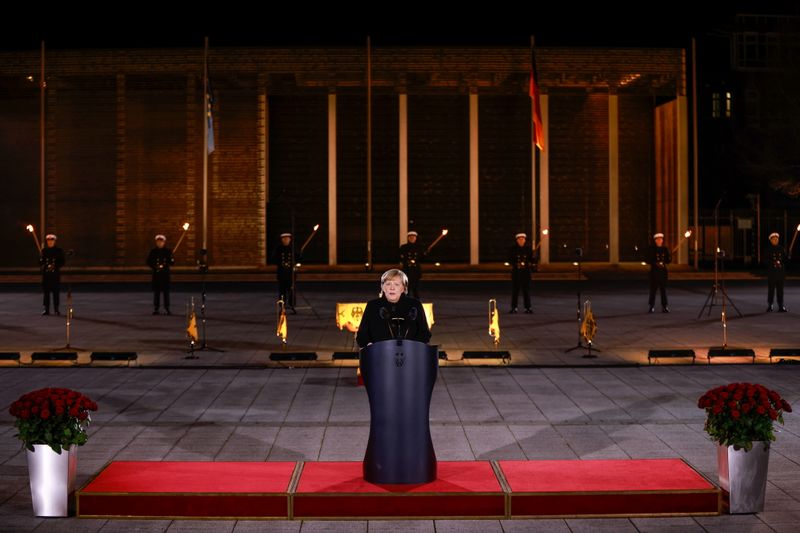 With God, roses and punk, German military honours Merkel