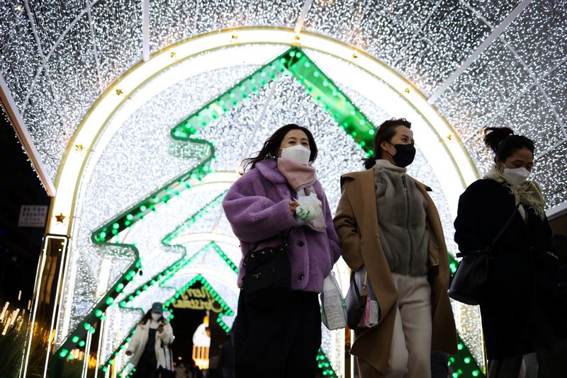 &copy; Reuters. Women wearing masks to prevent contracting the coronavirus disease (COVID-19) walk under a Christmas illumination at a shopping district in central Seoul, South Korea, December 1, 2021.    REUTERS/Kim Hong-Ji/file photo