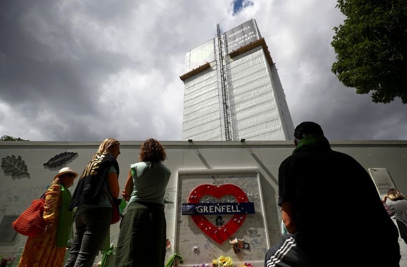 &copy; Reuters. FILE PHOTO: People attend a commemoration to mark the third anniversary of the Grenfell Tower fire in London, Britain June 14, 2020. REUTERS/Henry Nicholls/File Photo