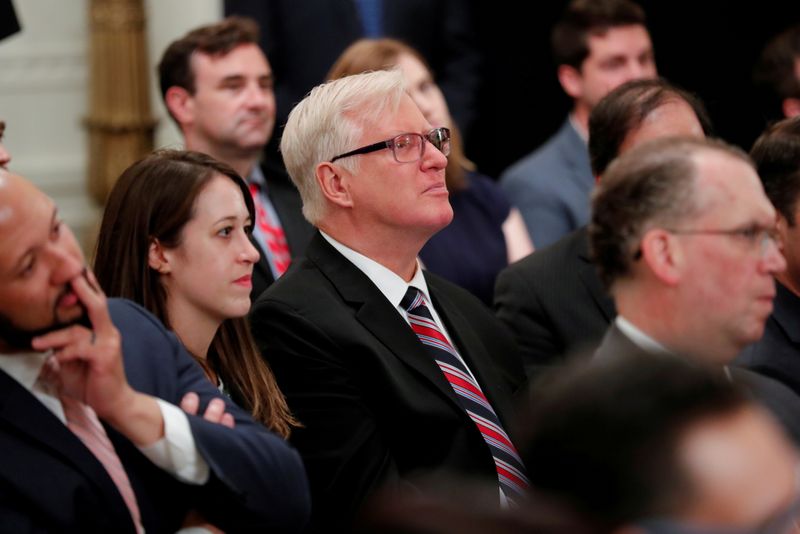 &copy; Reuters. FILE PHOTO: Gateway Pundit publisher Jim Hoft listens as U.S. President Donald Trump speaks during a "social media summit" meeting with prominent conservative social media figures in the East Room of the White House in Washington, U.S., July 11, 2019. REU