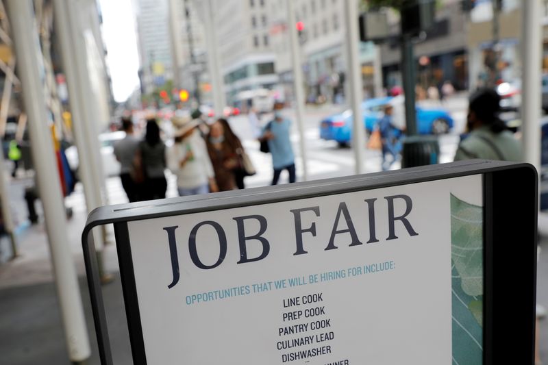 &copy; Reuters. FILE PHOTO: Signage for a job fair is seen on 5th Avenue after the release of the jobs report in Manhattan, New York City, U.S., September 3, 2021. REUTERS/Andrew Kelly