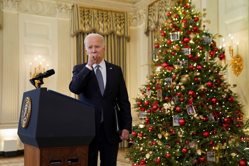 &copy; Reuters. U.S. President Joe Biden coughs as he delivers remarks on the November jobs report at the White House in Washington, U.S., December 3, 2021. REUTERS/Kevin Lamarque