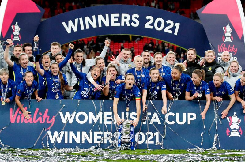 &copy; Reuters. Soccer Football - Women's FA Cup Final - Arsenal v Chelsea - Wembley Stadium, London, Britain - December 5, 2021 Chelsea players celebrate with trophy after winning the Women's FA Cup Final Action Images via Reuters/Andrew Boyers