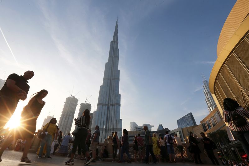 &copy; Reuters. FILE PHOTO: People are seen in front of Burj Khalifa, the world tallest building, in Dubai, United Arab Emirates March 12, 2020.   REUTERS/Satish Kumar