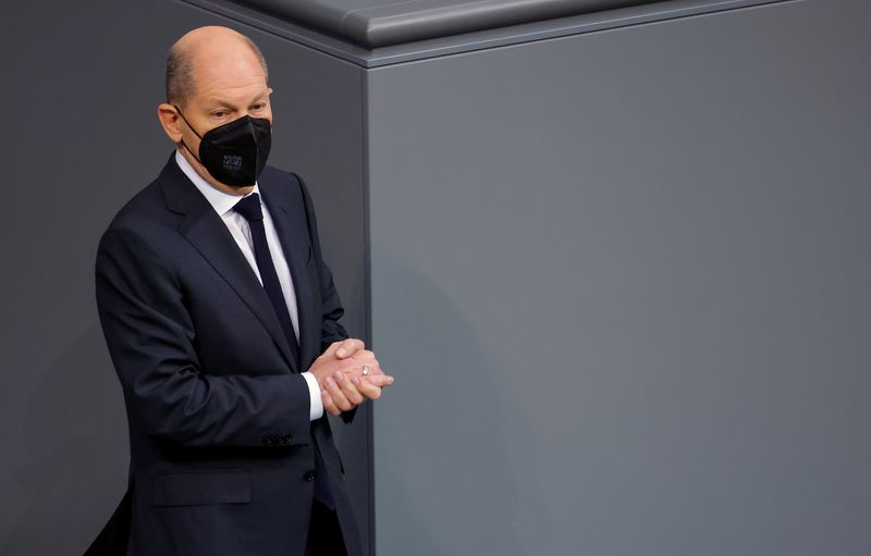 &copy; Reuters. Designated German Chancellor Olaf Scholz wears a protective mask at the Germany's lower house of parliament, the Bundestag, after signing a coalition government agreement in Berlin, Germany, December 7, 2021. REUTERS/Michele Tantussi