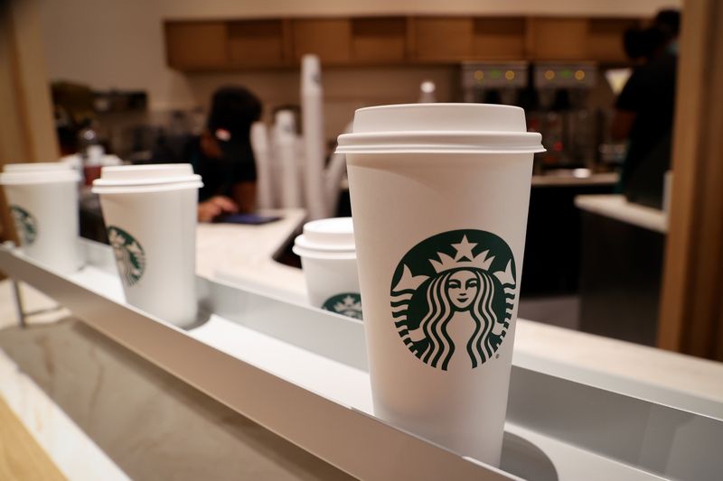 &copy; Reuters. FILE PHOTO: Starbucks beverage cups are displayed where customers will receive their orders at a new Starbucks store, its first-ever in partnership with Amazon Go that lets customers check out without a cashier, during a preview of the store which opens o