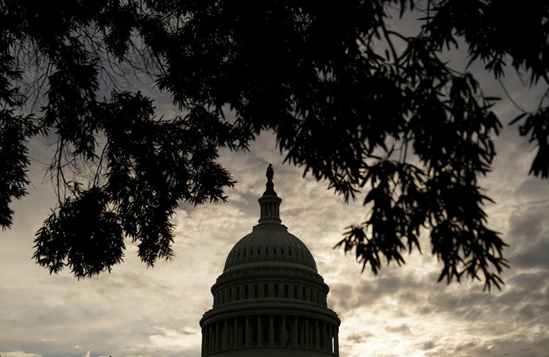 &copy; Reuters. FILE PHOTO: The sun rises behind the dome of the U.S. Capitol in Washington, U.S., October 4, 2021. REUTERS/Kevin Lamarque