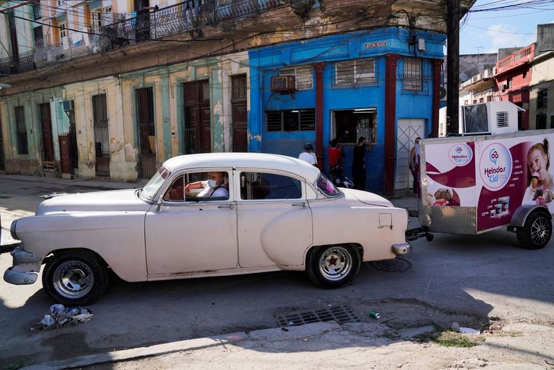 &copy; Reuters. A delivery man drives a car with a trailer containing Cid Ice Cream, a brand run by Cuban entrepreneurs Henry and Yendri Garcia, in Havana, Cuba December 6, 2021. REUTERS/Natalia Favre 