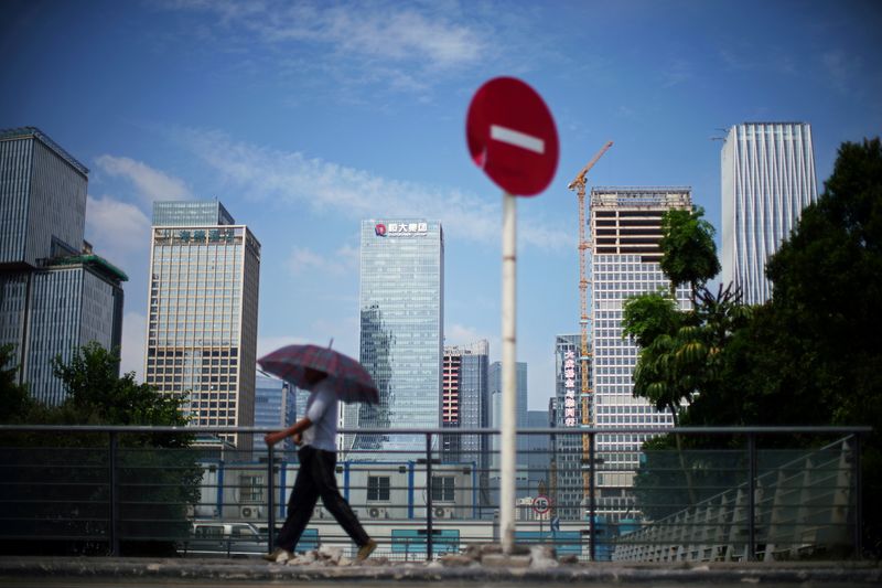 &copy; Reuters. FILE PHOTO: A man walks past a No Entry traffic sign near the headquarters of China Evergrande Group in Shenzhen, Guangdong province, China September 26, 2021. REUTERS/Aly Song/File Photo