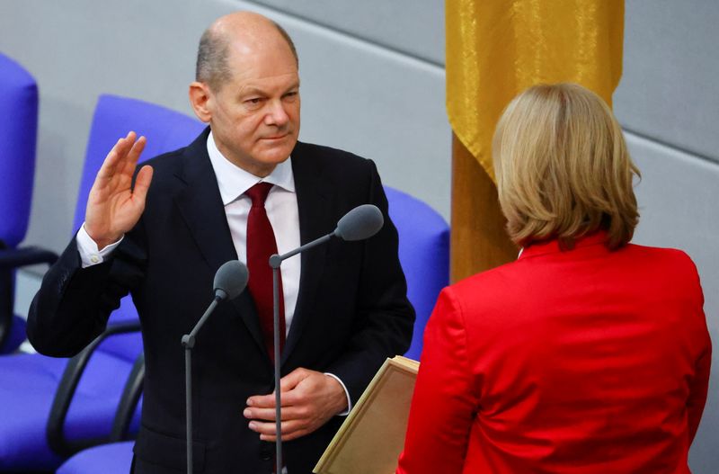 &copy; Reuters. Newly elected German Chancellor Olaf Scholz is sworn-in by Parliament President Baerbel Bas during a session of the German lower house of parliament Bundestag, in Berlin, Germany, December 8, 2021. REUTERS/Fabrizio Bensch