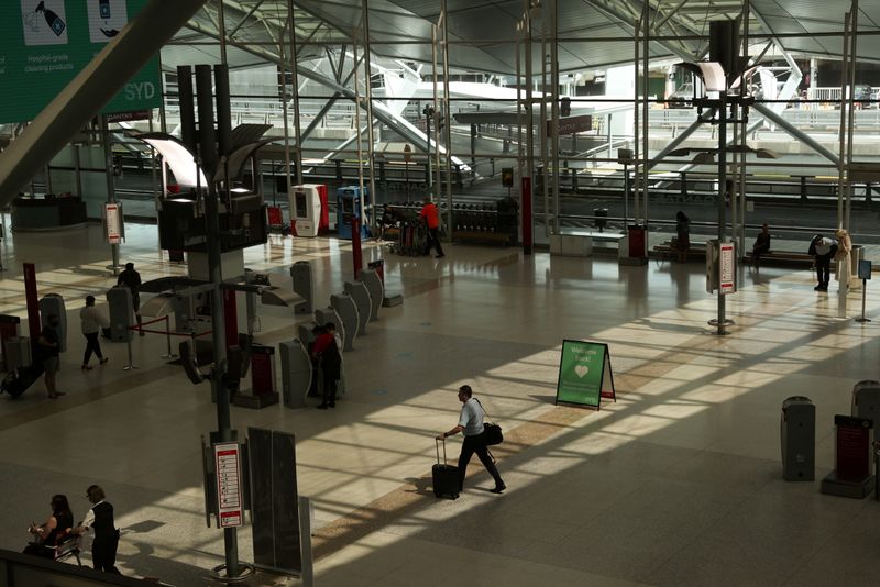 &copy; Reuters. A traveller walks through a domestic terminal at Sydney Airport in Sydney, Australia, November 16, 2020.  REUTERS/Loren Elliott/File Photo