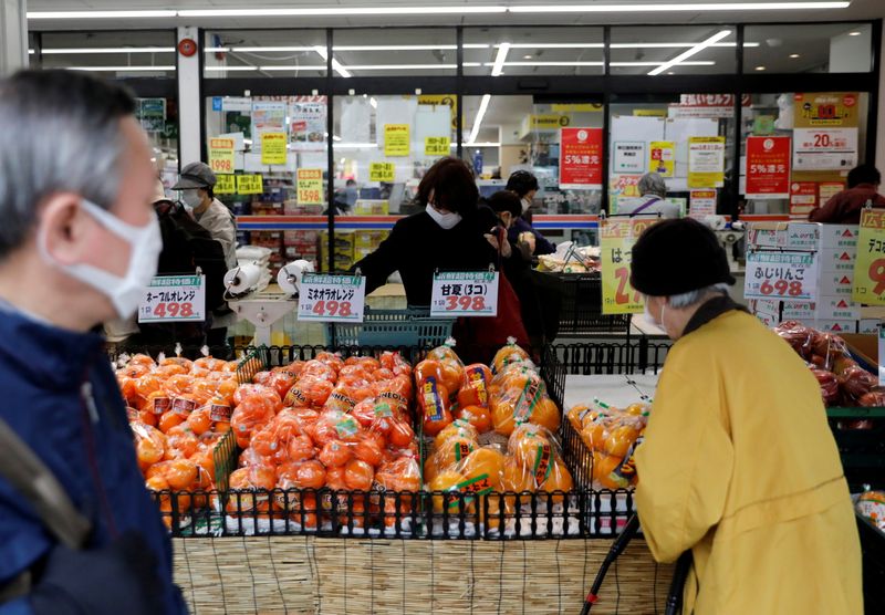 &copy; Reuters. FILE PHOTO: Shoppers wearing protective face masks, following an outbreak of the coronavirus disease (COVID-19), are seen at a supermarket in Tokyo, Japan March 27, 2020.    REUTERS/Issei Kato/File Photo  GLOBAL BUSINESS WEEK AHEAD